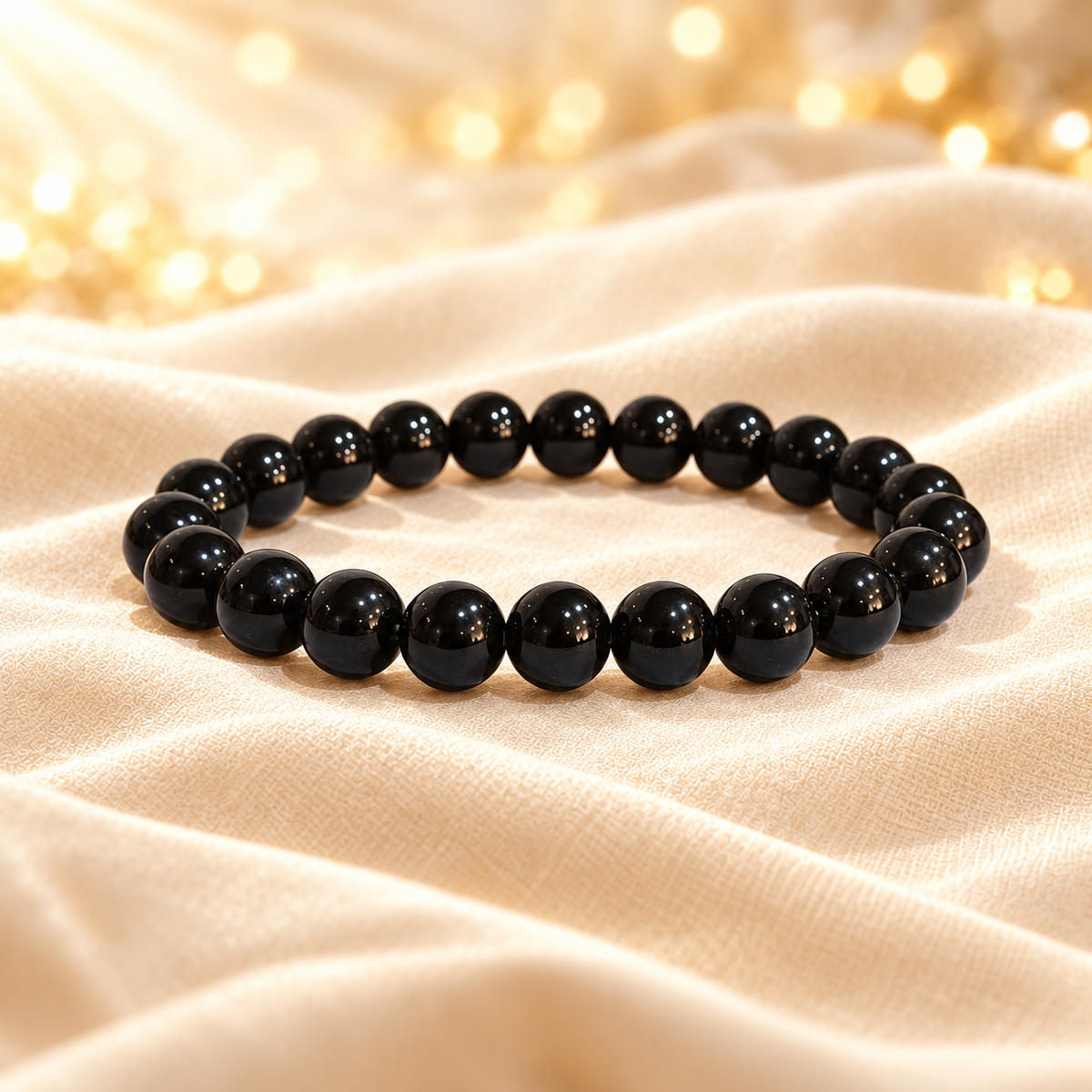 Black Tourmaline Bracelet – 8mm Natural Gemstone Jewellery on champagne fabric