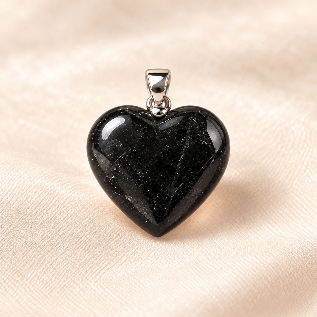 black tourmaline heart pendant on ivory with soft shadow