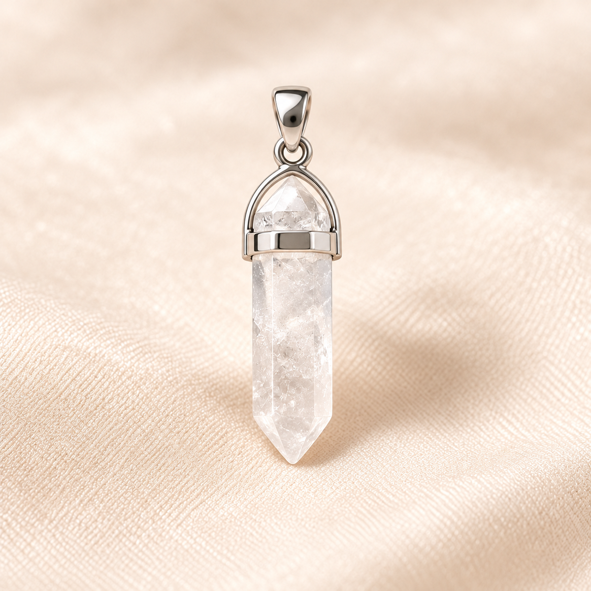clear quartz pencil pendant on ivory with soft shadow