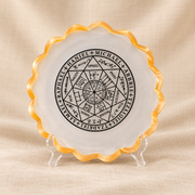 Winged-Figure Selenite Bowl – Decorative Symbol Design on cream linen