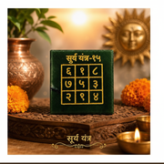 Surya Yantra on wooden tray with golden sun idol and marigold