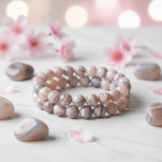 Natural Botswana Agate Bracelet on white marble with agate stones and pink flowers