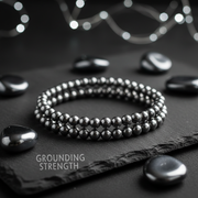 Double Layer Natural Hematite Bracelet on dark slate with hematite stones and silver light