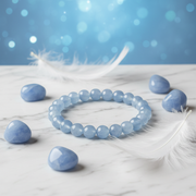 Natural Angelite Bracelet on white marble with angelite stones and white feathers