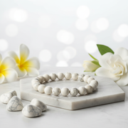 Natural White Howlite Bracelet on white marble with white flowers