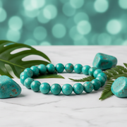 Natural Amazonite Bracelet on white marble with amazonite stones and green leaves