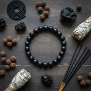 Natural Karungali Ebony Wood Bracelet flat lay with rudraksha and black crystals