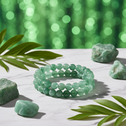 Natural Green Aventurine Bracelet on white marble with green leaves