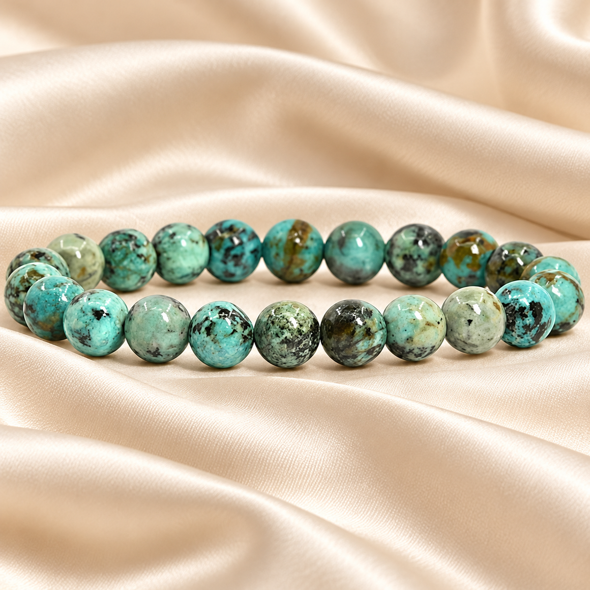 Natural African Turquoise Bracelet – 8mm Gemstone Jewellery on champagne fabric