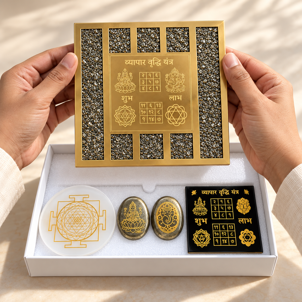 Illustrative lifestyle image of the Pyrite plaque held above the five-piece presentation box